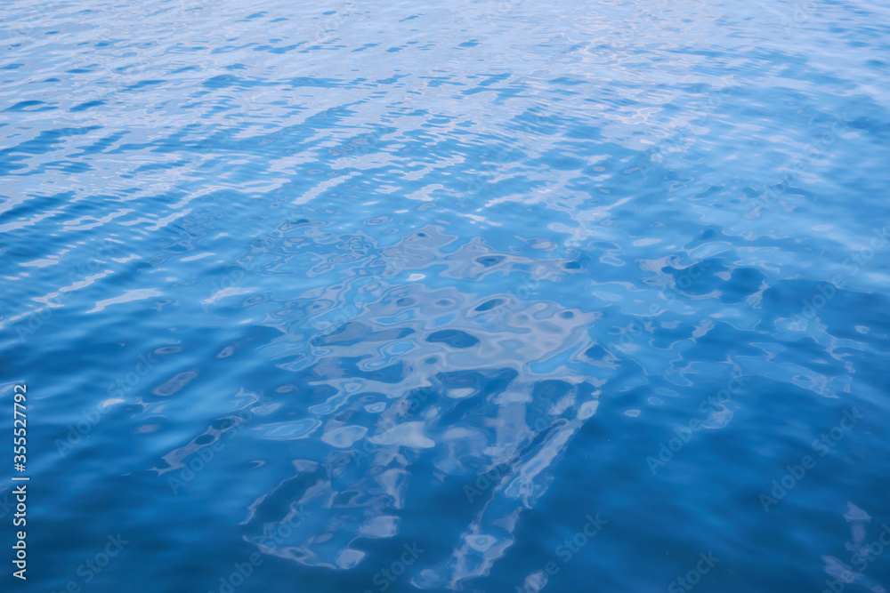 Obraz premium Background from the blue surface of the water of the sea, ocean. Smooth the water.