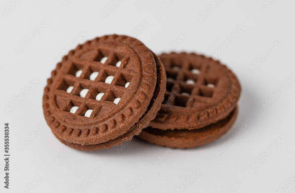 Macro photo of chocolate cookies with filling on a white background. Isolate, close up Macro photo of chocolate cookies with filling on a white background. Isolate, close up