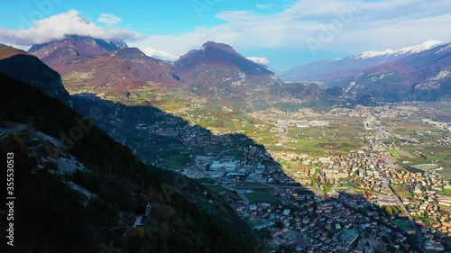 Aerial video with drone, view of the beautiful Riva del Garda town and Lake Garda lake surrounded by mountains in the autumn time , Trentino Alto Adige region, Lago di garda, italy