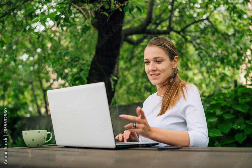 Happy beautiful young caucasian woman smiling and working at home Happy beautiful young caucasian woman smiling and working at home