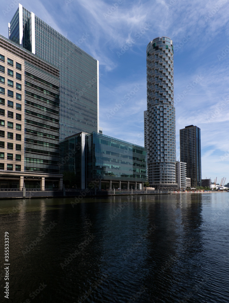 Naklejka premium A view of the modern Canary Wharf skyline in old Victorian docks on Isle of Dogs, London, United Kingdom.