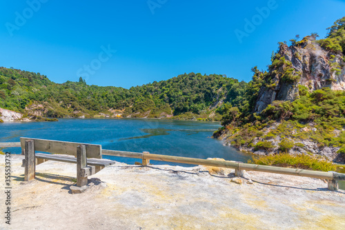 Bench overlooking Frying pan lake and echo crater at Waimangu volcanic valley un New Zealand photo