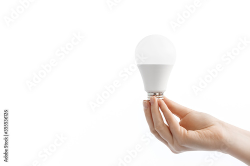 LED light lamp (bulb) in hand, isolated on white background.