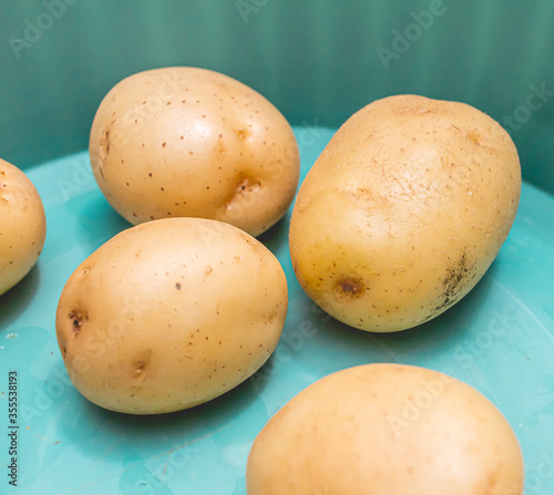 English potatoes inside a green colored bowl.
 photo