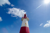 white and red lighthouse with blue and clod background ponta de humaita salvador bahia brazil