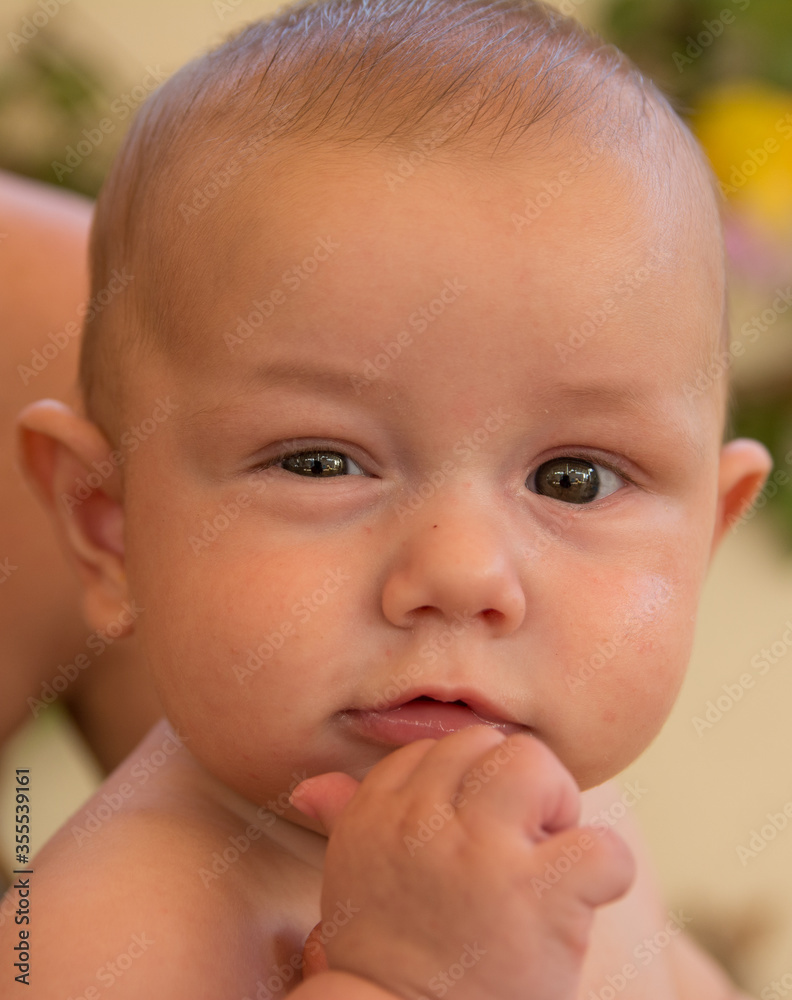 Close-up of a baby's face, with a funny expression. Pretty Baby. New families Close-up of a baby's face, with a funny expression. Pretty Baby. New families