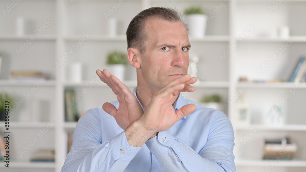 Portrait of Middle Aged Businessman saying No with Hand Gesture