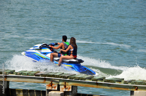 Jet skiers riding in tandem.