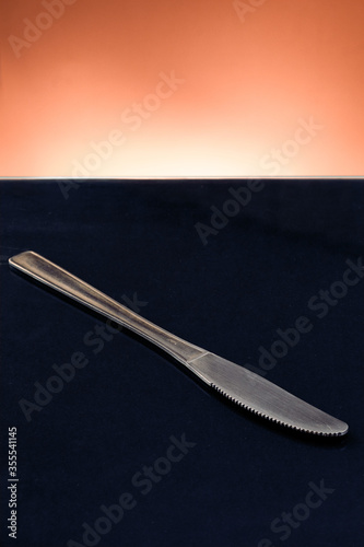 metallic knife in black table