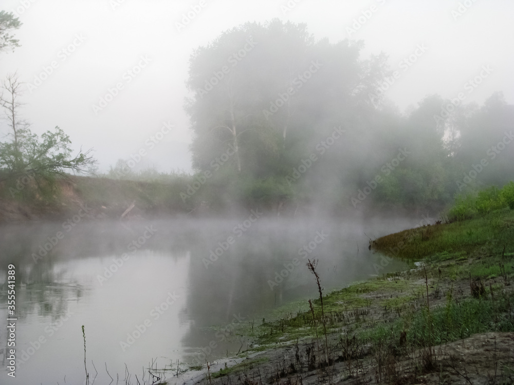 Fototapeta premium A river on a foggy morning at sunrise. Ukrainian nature