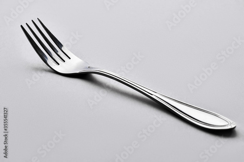 Isolate metallic fork in Grey background
