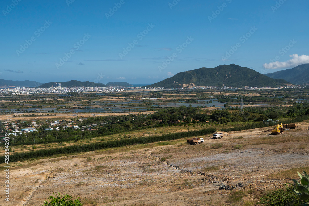 Fototapeta premium Wheel loader excavator with a trucks on a new construction site.