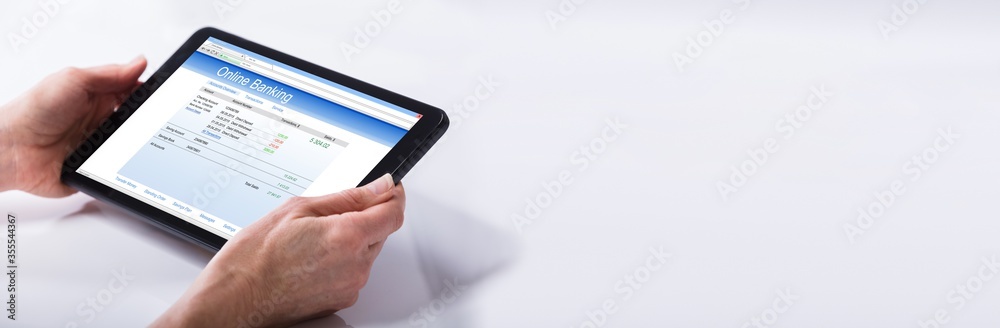 Person Using Online Banking Service On Digital Tablet Person Using Online Banking Service On Digital Tablet