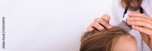 Doctor Examining Girl's Hair