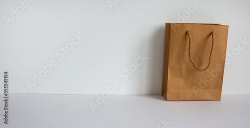 Disposable bag of kraft paper on a beautiful white background, copy space.