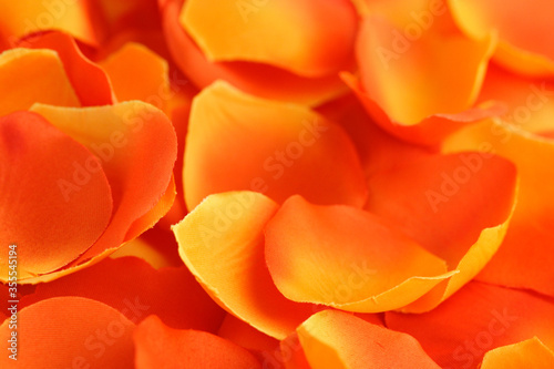 Artificial rose red-yellow petals background.