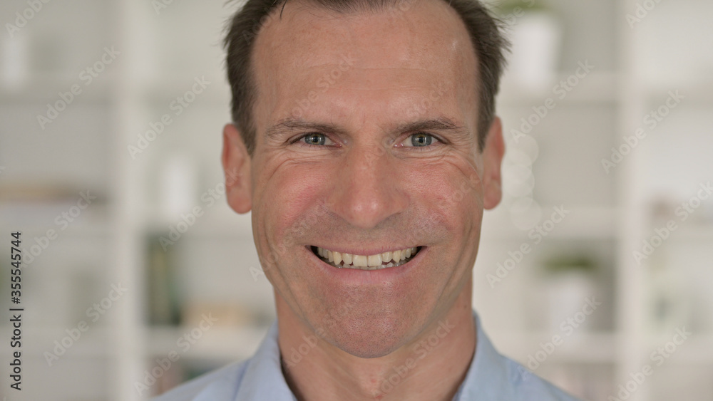 Close Up of Cheerful Middle Aged Businessman Smiling at Camera Close Up of Cheerful Middle Aged Businessman Smiling at Camera