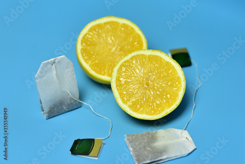 beautiful sliced lemons and tea on a blue background yellow photo