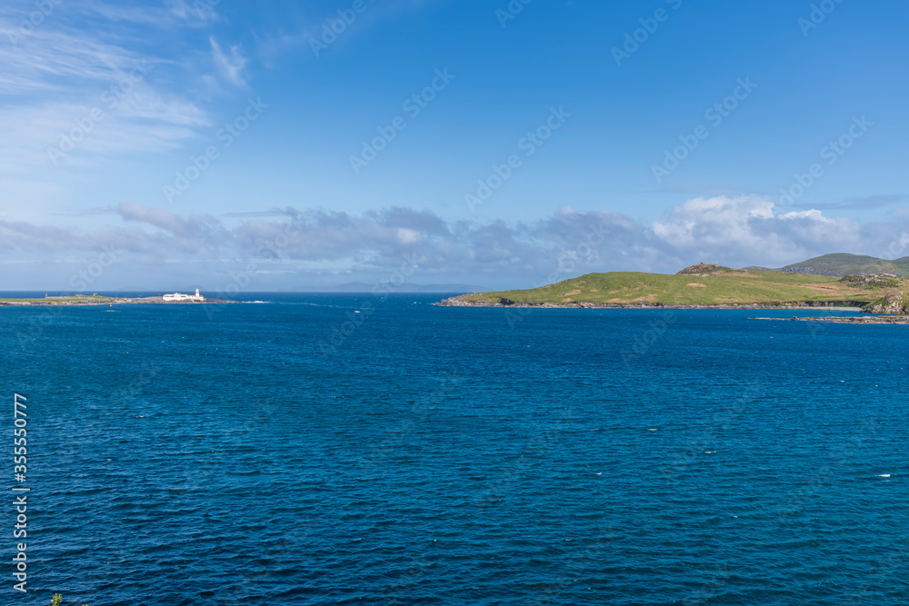 Beautiful view of Valentia Island Lighthouse at Cromwell Point. Locations worth visiting on the Wild Atlantic Way. Scenic Irish countyside on sunny summer day, County Kerry, Ireland.