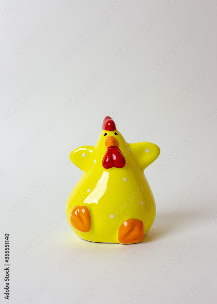 Yellow ceramic rooster on a white background. Ceramic figurine. Year of the rooster Yellow ceramic rooster on a white background. Ceramic figurine. Year of the rooster