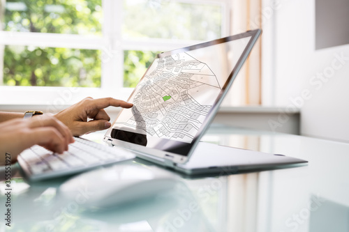 Female Executive Looking At Cadastre Map photo