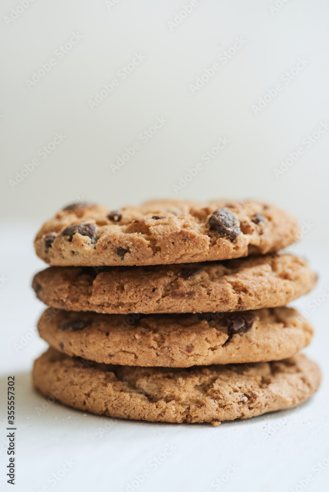 Group of chocolate chip cookies and crumbs on beige background