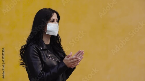 Woman with mask applauds 