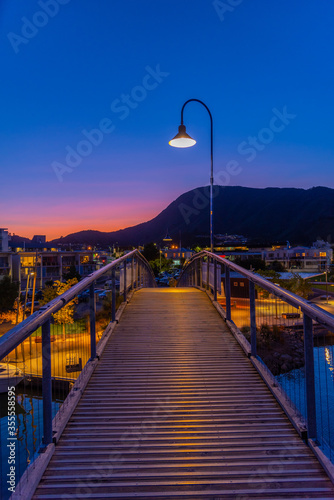 Sunset view over a wooden bridge leading to marina in Picton, New Zealand photo