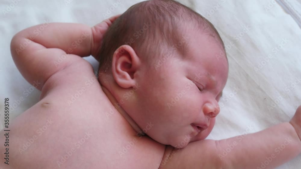 dissatisfied baby whines lying on white dissatisfied baby whines lying on white