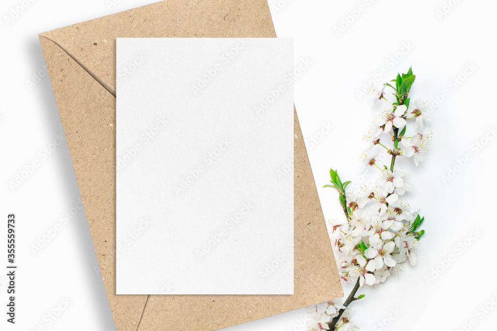 Invitation card and craft paper envelope with cherry branch blossom on clean white background minimalist clean mockup Invitation card and craft paper envelope with cherry branch blossom on clean white background minimalist clean mockup