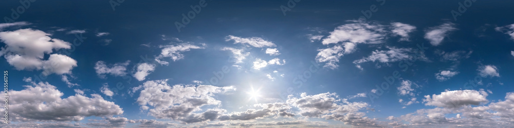 blue sky with beautiful fluffy cumulus clouds without ground. Seamless hdri panorama 360 degrees angle view without ground for use in 3d graphics or game development as sky dome or edit drone shot