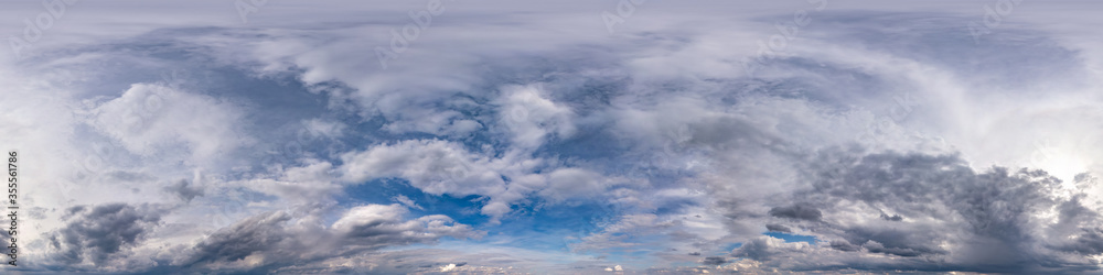 Obraz premium blue sky with beautiful dark clouds before storm. Seamless hdri panorama 360 degrees angle view with zenith for use in 3d graphics or game development as sky dome or edit drone shot