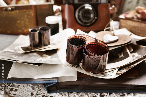 vintage style still life with old photographs and camera in sepia