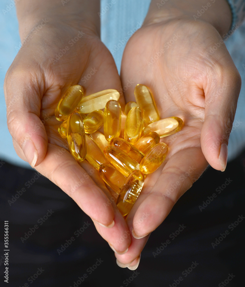 Vitamin capsules. Soft gel capsules on the surface of natural stone. Сlose up fish oil on gold background. Omega 3. Сoncept of health. Омега 3. gold pattern Vitamin capsules. Soft gel capsules on the surface of natural stone. Сlose up fish oil on gold background. Omega 3. Сoncept of health. Омега 3. gold pattern