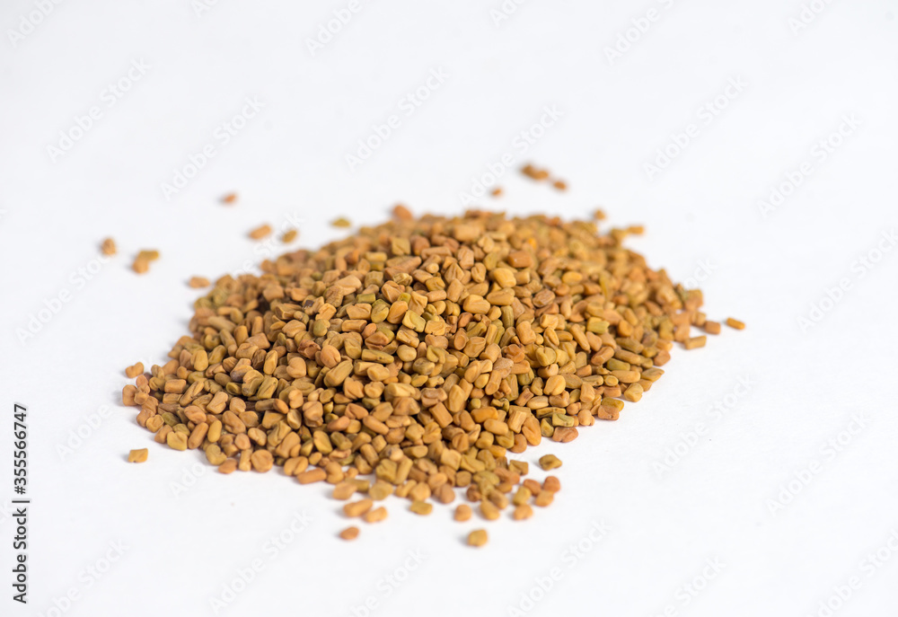 Helba. Background of fenugreek seeds (methi dana, helba or shambala) Helba seeds. Fenugreek on a white background. Healthy herbal tea. Хельба. Gluten-free. Фунгерек. Шамбала. Пажитник. Fungere Helba. Background of fenugreek seeds (methi dana, helba or shambala) Helba seeds. Fenugreek on a white background. Healthy herbal tea. Хельба. Gluten-free. Фунгерек. Шамбала. Пажитник. Fungere