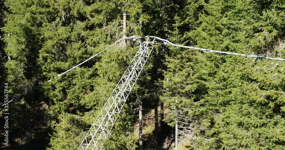 Aerial of storm damage, bent power pole in forest. Electricity line down in 4K