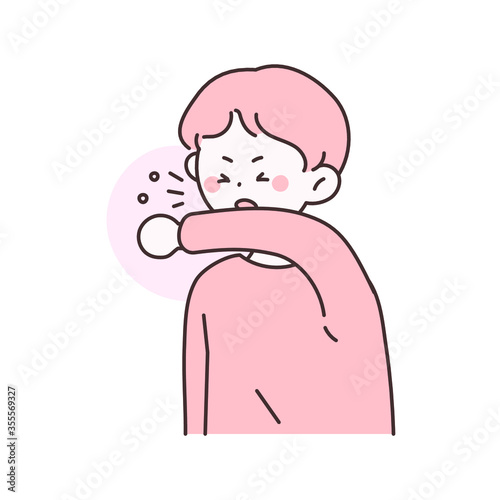코로나 바이러스 확산을 방지하기 위해 팔로 기침을 막는 남자.
