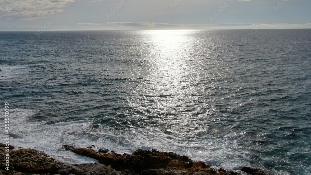 contemplate the sunset and the sea from the cliffs next to the Golden sand