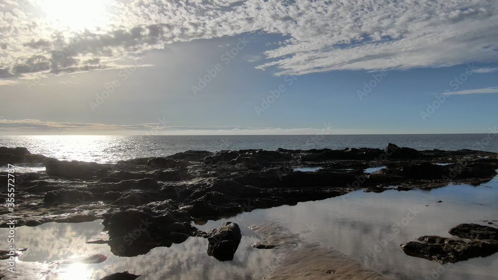 contemplate the sunset and the sea from the cliffs next to the Golden sand