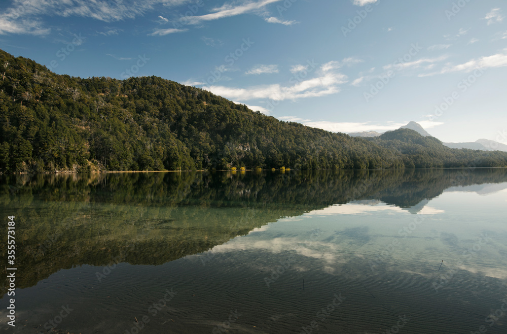 Panorama view of Lake Espejo Chico in San Martin de los Andes, Patagonia Argentina. Beautiful mountain forest and sky reflection in water