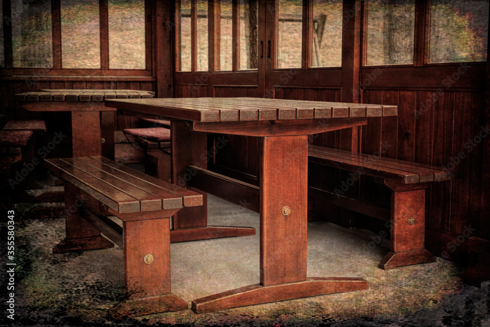 Tables and benches made of solid wood in log cabin. Grunge Style Tables and benches made of solid wood in log cabin. Grunge Style