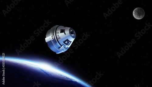 Fototapeta Naklejka Na Ścianę i Meble -  Spaceship / spacecraft flying through the outer space on a space mission with earth and moon on the backgrond. Elements of this image furnished by NASA.
