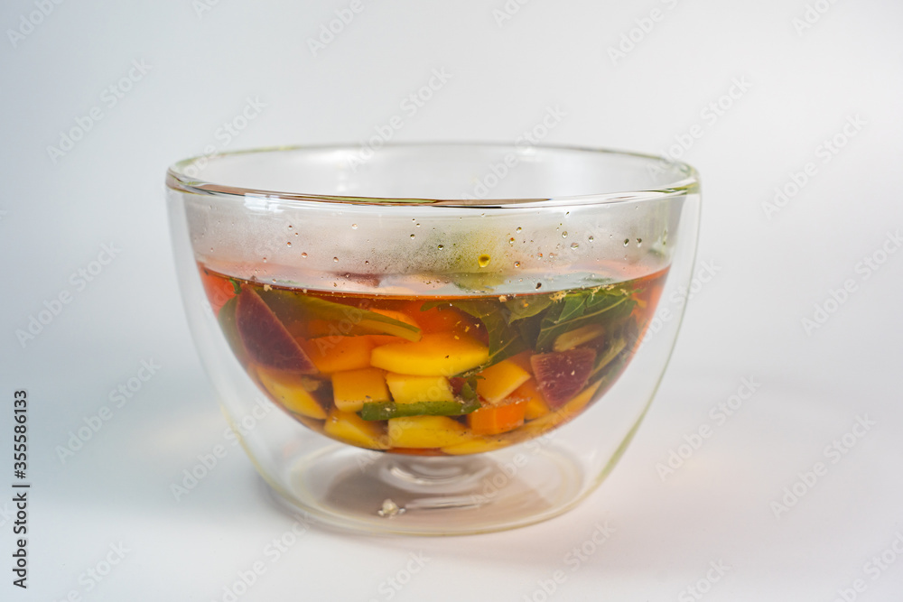 Vegetables soup in double-walled glass bowl on white background Vegetables soup in double-walled glass bowl on white background