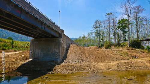 Side view of aconcrete bridge with steel beams photo