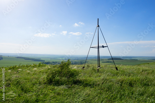A hilltop triangulation map point. Landscape of countryside view from the hill.