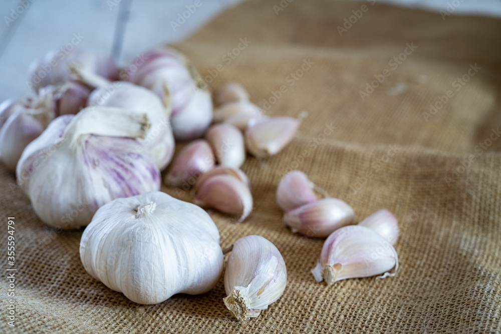 Garlic cloves and garlic on a wooden table. Garlic cloves and garlic on a wooden table.