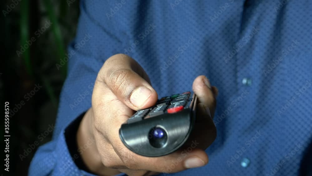 close up of man hand holding tv remote. close up of man hand holding tv remote.