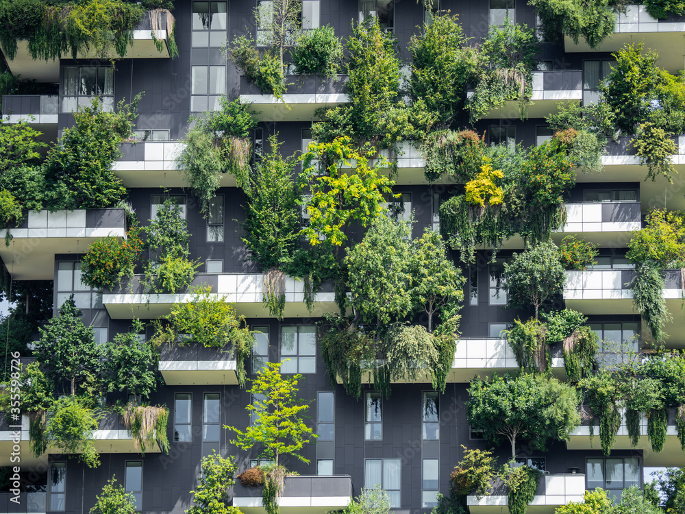 Milano, Italy. Bosco Verticale, a close up view at the modern and ecological skyscrapers with many trees on each balcony. Modern architecture, vertical gardens, terraces with plants - obrazy, fototapety, plakaty 