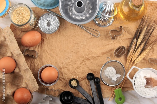 Baking Background with Baking Ingredients such as Egg, Sesame Seed, Flour, Oil, and Baking Utensils. Suitable for Background or Wallpaper