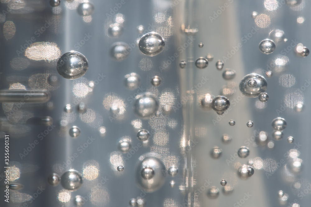 A selective focus shot a abstract background of glowing and iridescent bubbles. Blurred background.